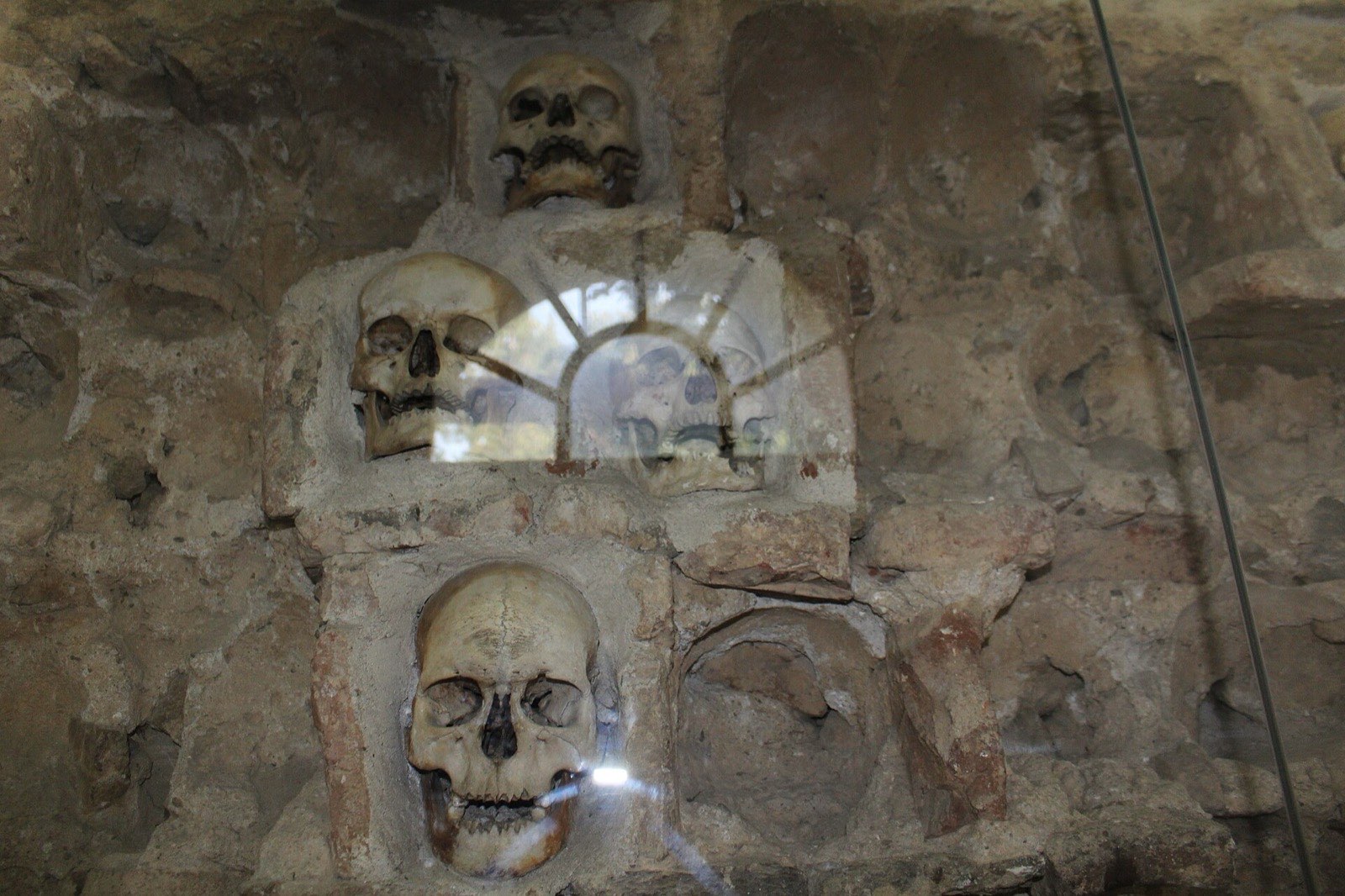 The tower wall with embedded human skulls, inside its chapel