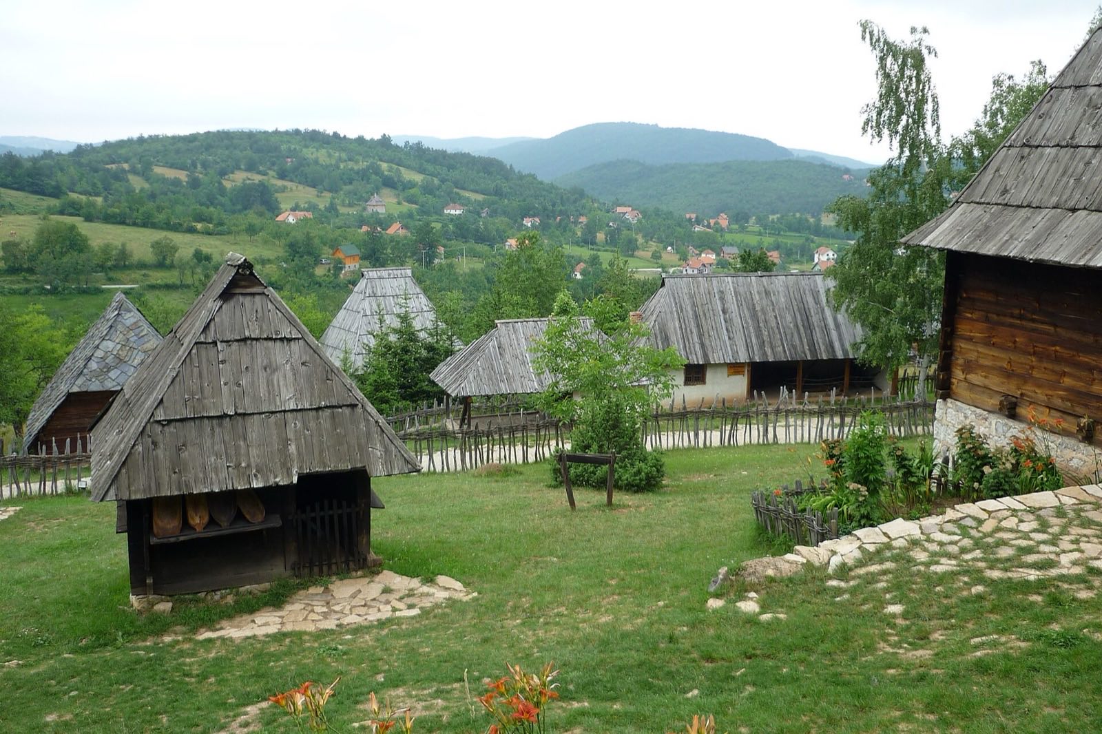 Steep-roofed timber houses on a green hillside