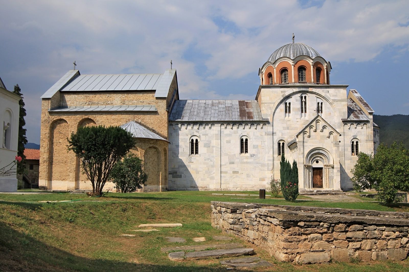 White marble church inside a walled monastery ring